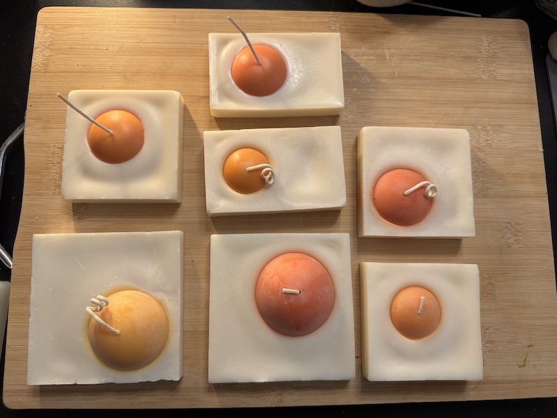photo of a bunch of my egg candles over the past several months of prototyping and iterating