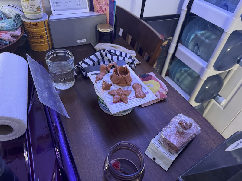 a photo of my clay projects: a snake, cat head, flower, peanut and a "worm bowl"