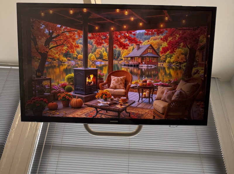 photo from a dentist chair showing a tv up above me showing a weird still ai-generated image of an autumn scene on the deck near a pond