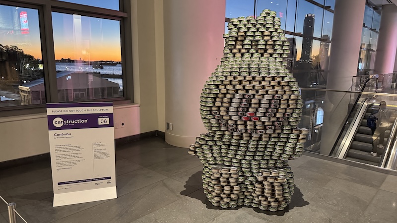 a very large labubu made out of cans, on display inside brookfield place