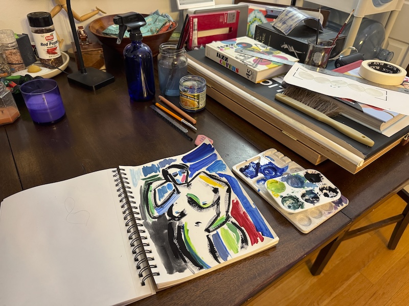 photo of a bunch of books piled on my painting, next to that is a sketchbook painting that i made as i swatched paint colors during my primary painting