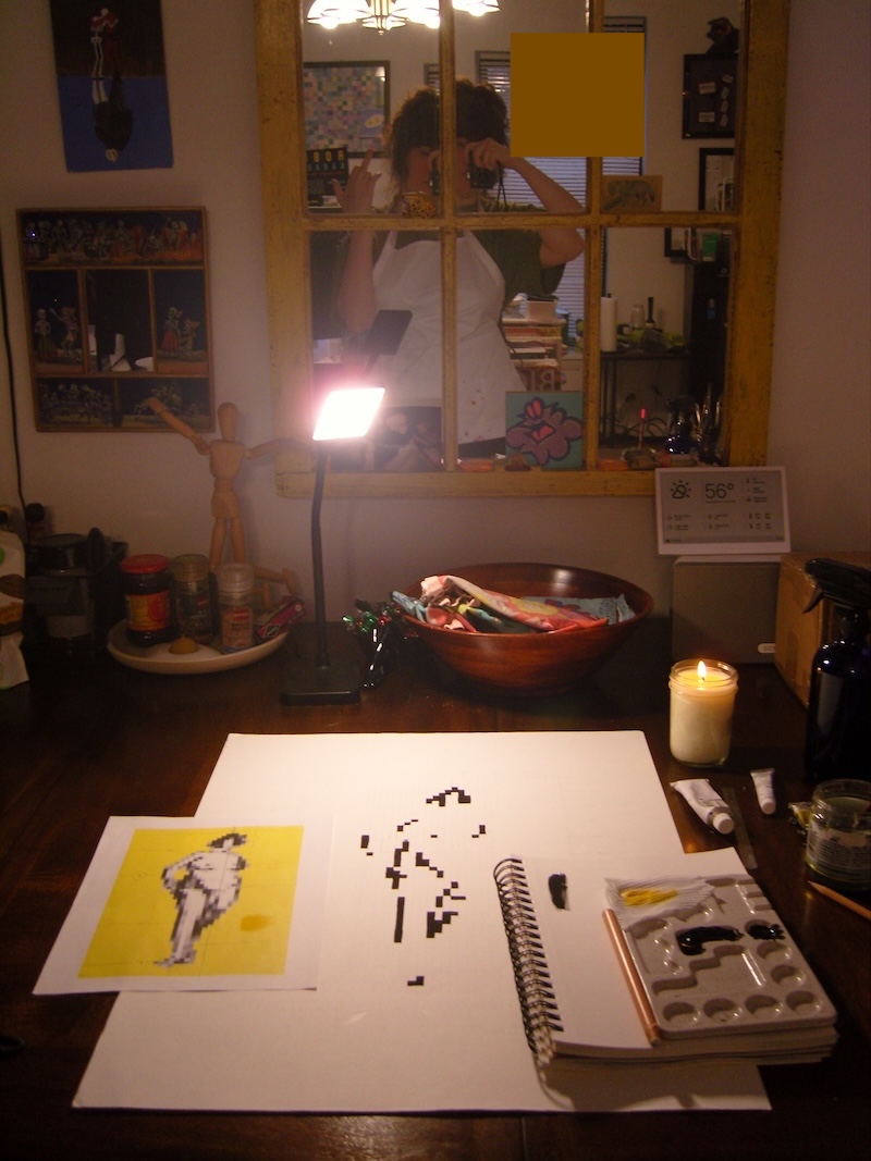 my painting in progress, with black pixels of the figure done. on the wall mirror you see a reflection of me giving the finger. we are at the dining room table again.