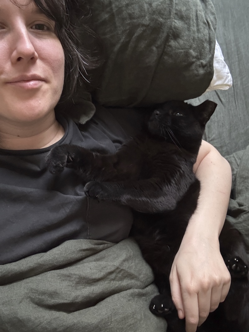 photo of me laying in bed with pumagreg in my arm looking funny