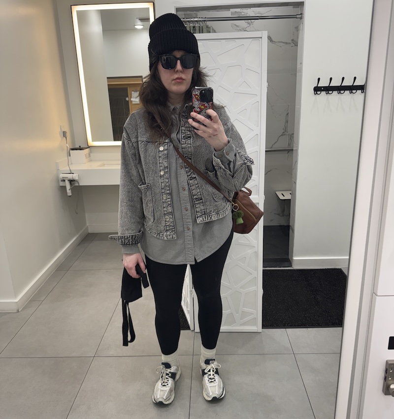 photo of me in the gym bathroom mirror after a workout and bundled up to go outside in my black beanie, gray flannel and jacket