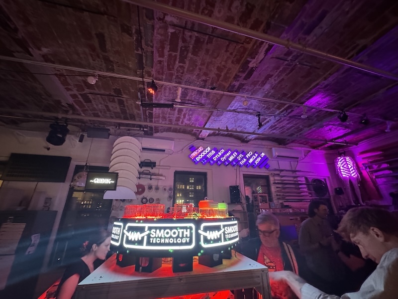 photo of the robot bartender and party leaderboard on the wall at smooth technology's office during a party