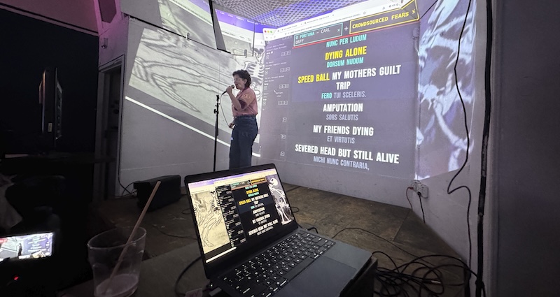 a photo of one of our incredible robot karaoke regulars singing crowdsourced fears to the tune of "o fortuna"