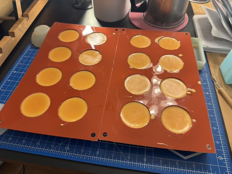 candle making photo where i'm making egg yolks out of wax in two silicone mats