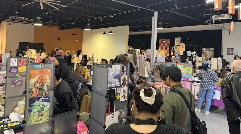 photo i took of the jersey book fair in one section, there's lots of booths and tables of young artists selling zines, stickers, books and prints